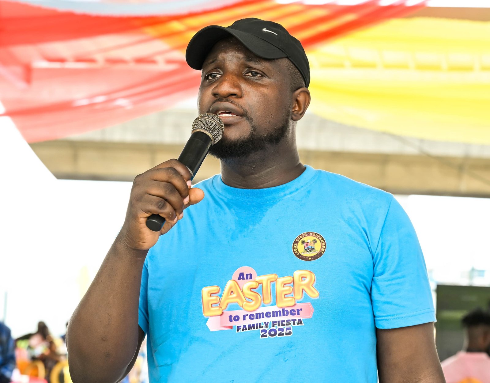 Abayomi speaking at a family fiesta event