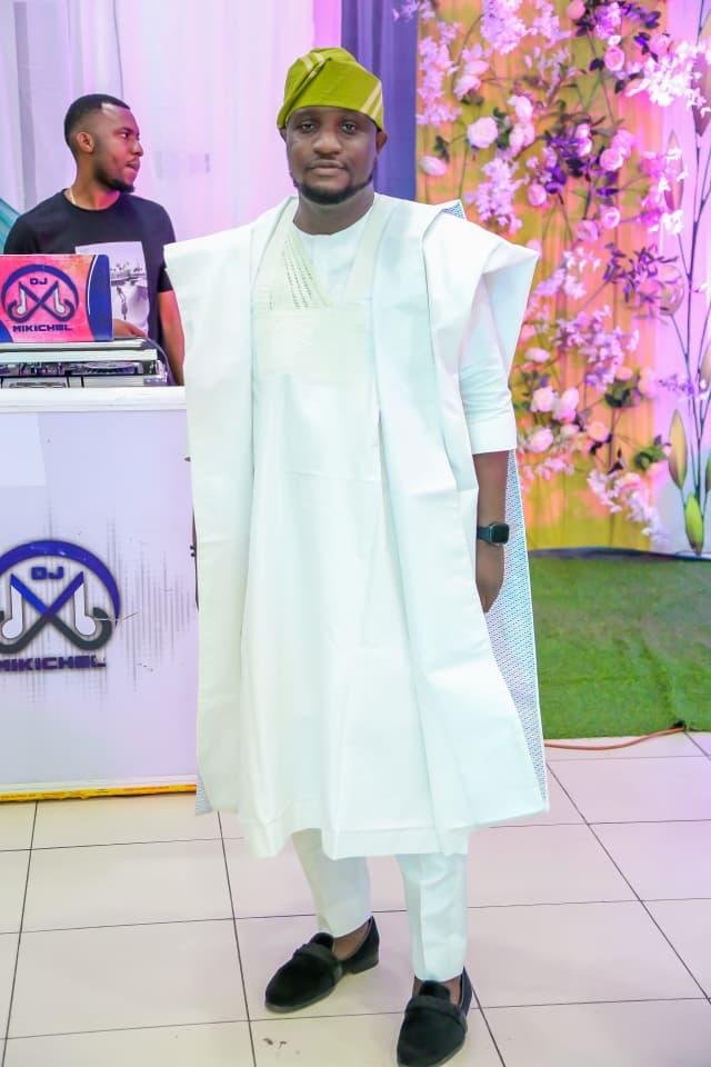 Abayomi in white traditional attire at an event